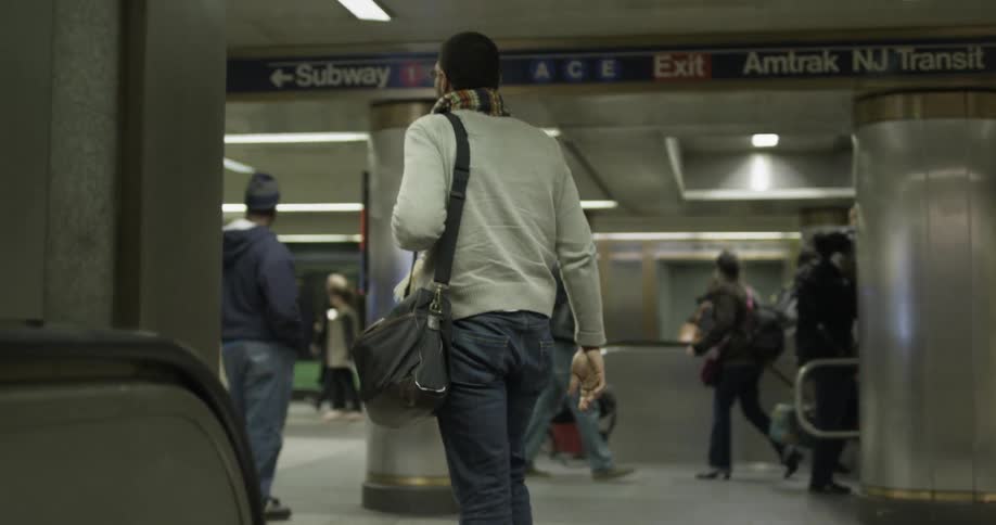 People moving through a public transportation area underground