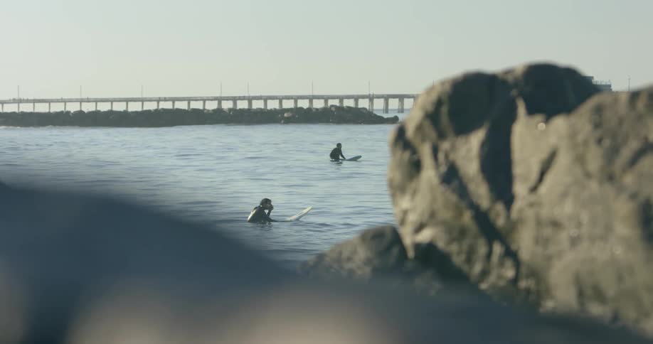 Surfers float in the ocean