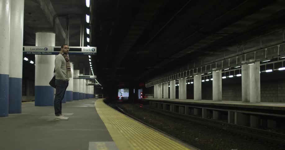 Man waits on subway platform
