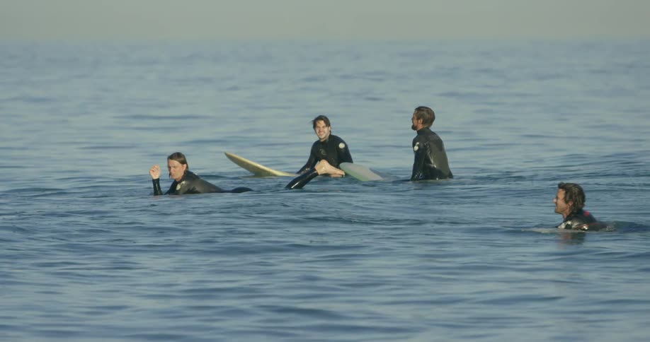 Surfers wait for waves