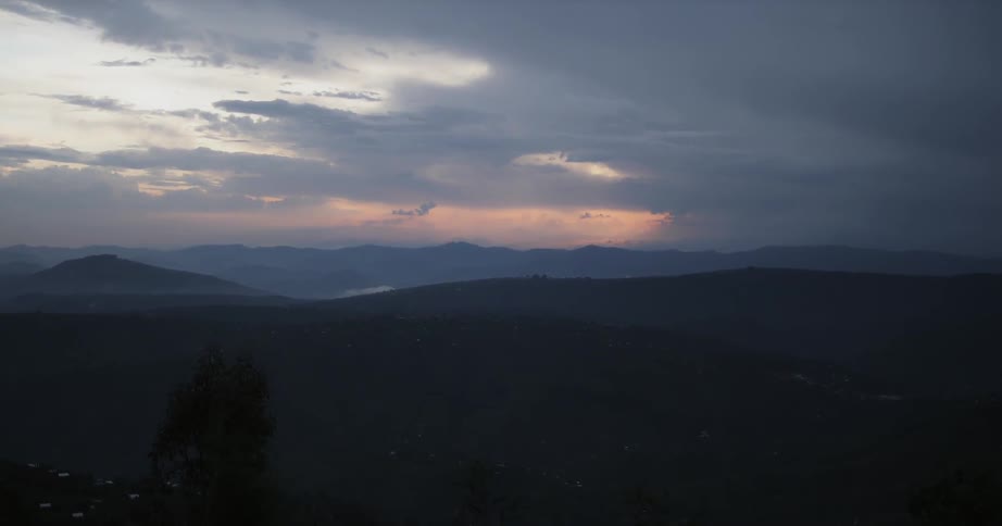 The sun sets over mountains