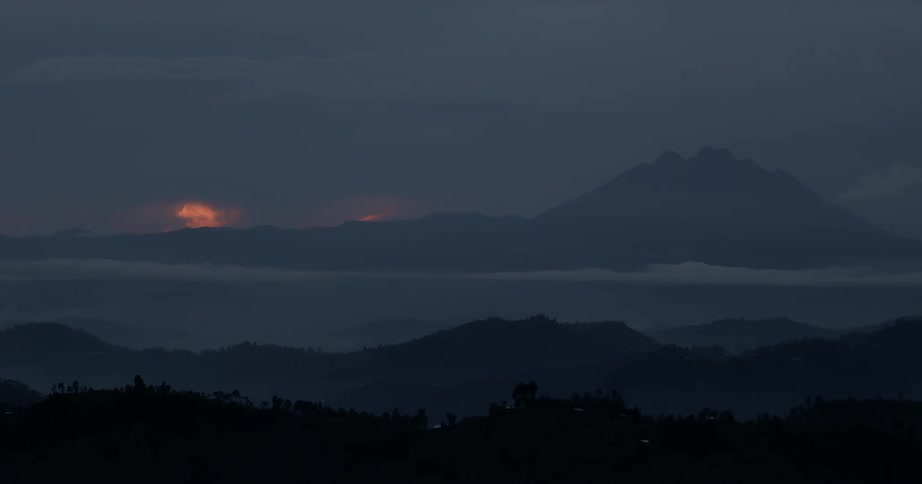 The sun sets over mountains