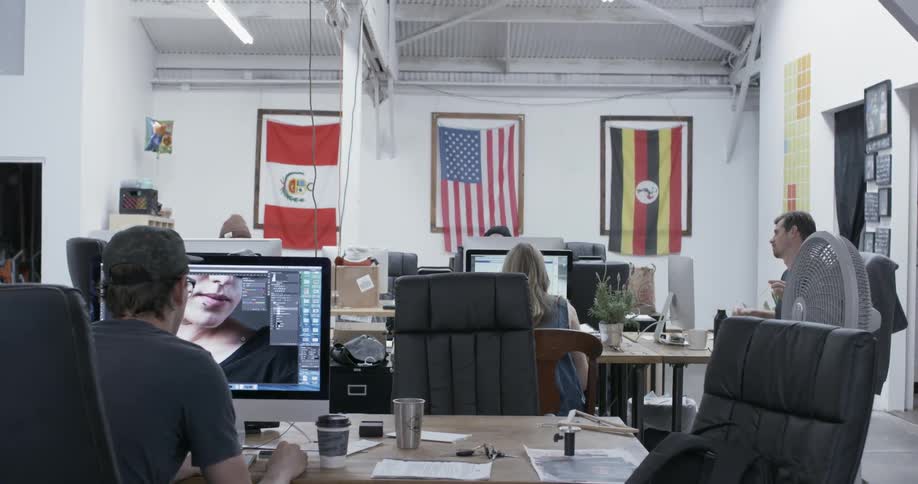Employees work on computers in an office