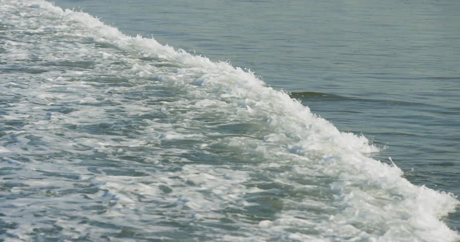 Ocean waves break as they come to shore