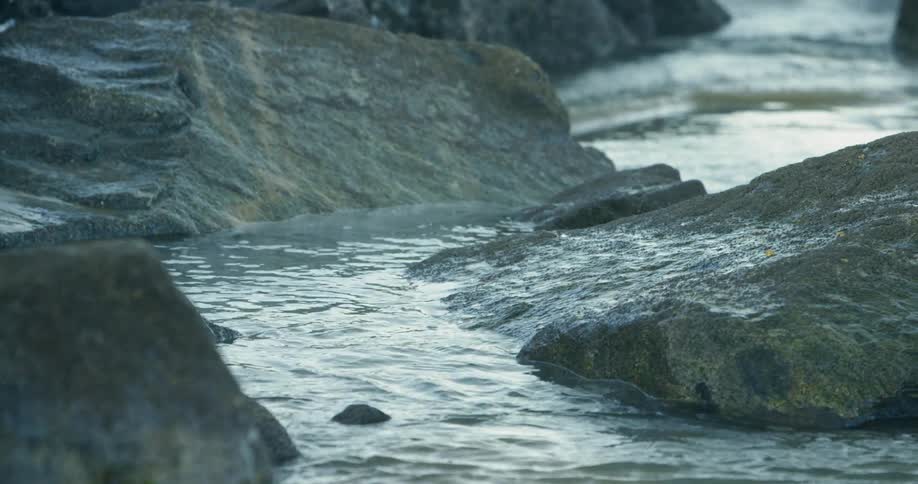 Water flows through a narrow rocky stream