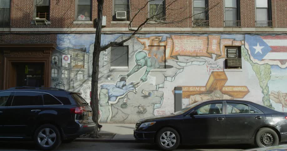 A nice wall mural is on the side of a building on a city street