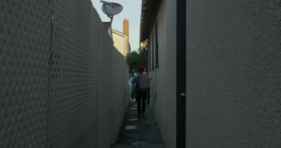A man walks down the alley