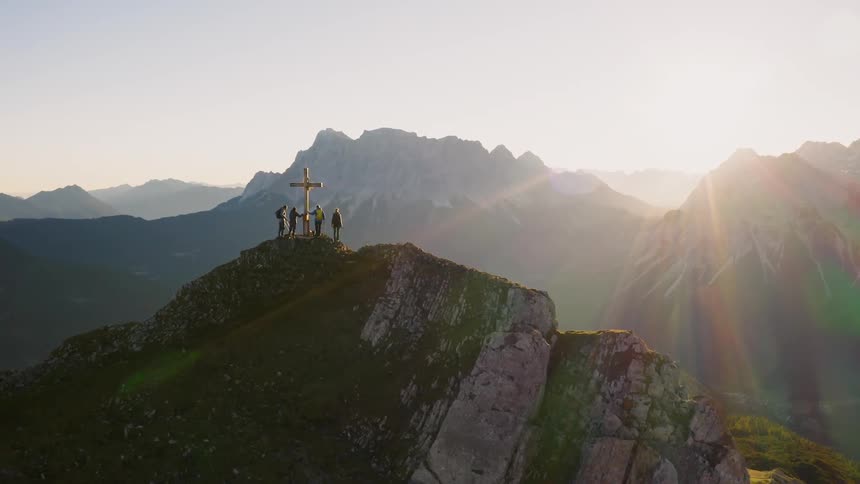 The sun sets over mountains
