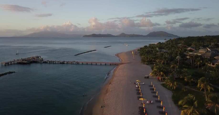 An ocean coast is shown at sunset