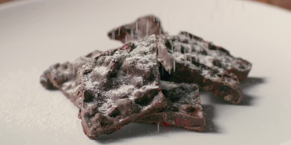 Powdered sugar is sprinkled on dessert