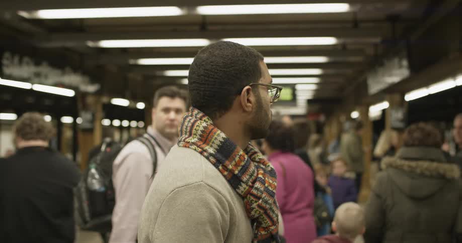 People wait on subway platform