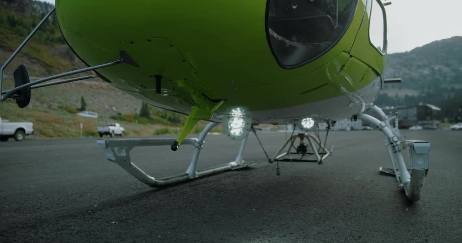The lights under the landed helicopter are flashing