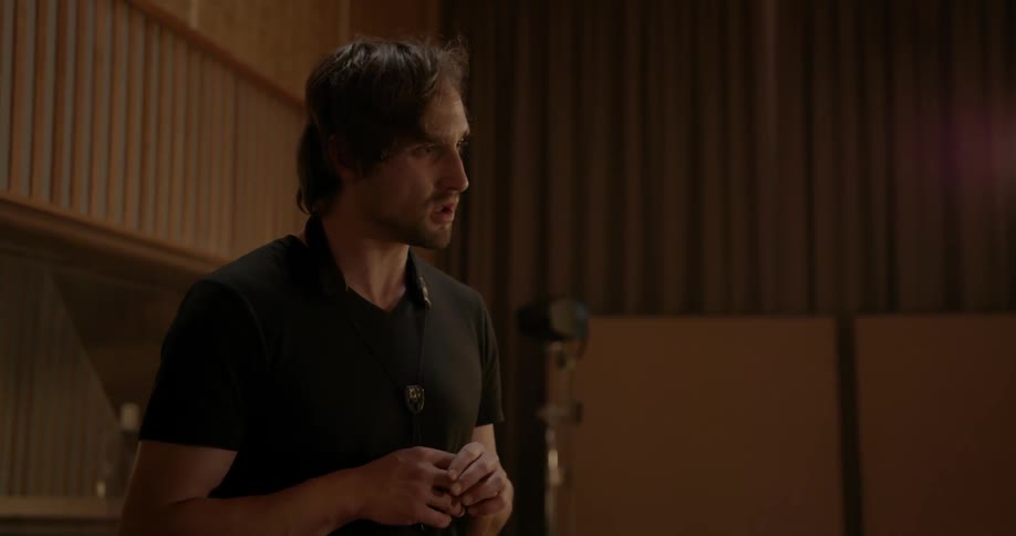 A man talks in a music studio