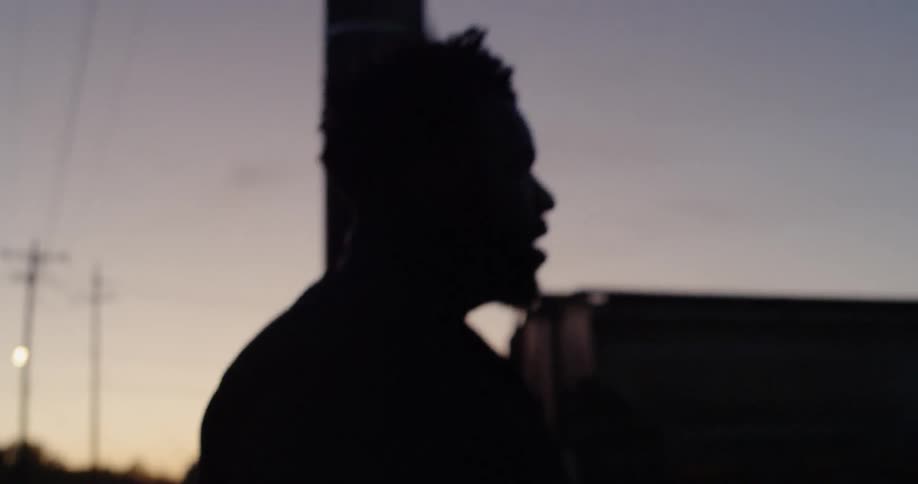 Man walks outside at dusk