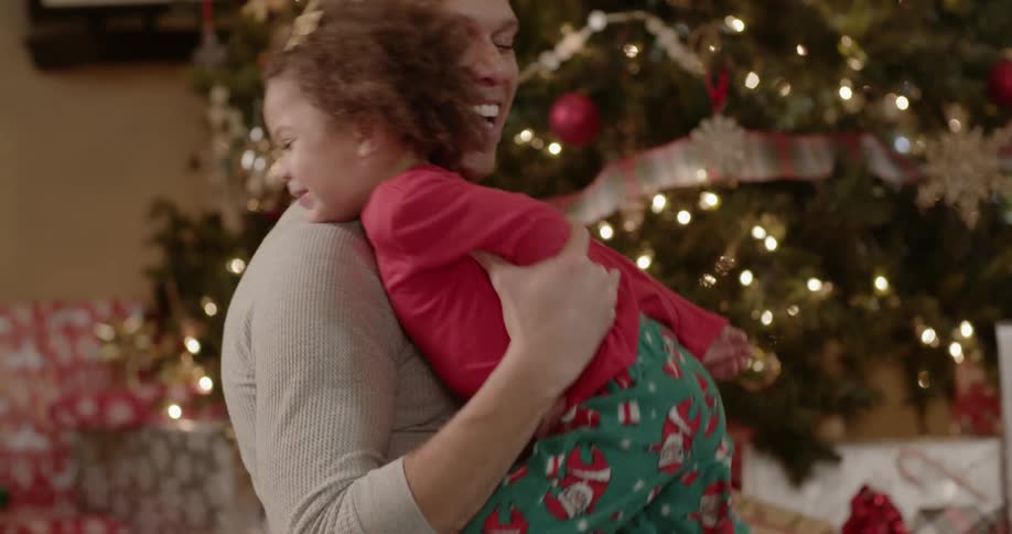 A family celebrate christmas while sitting on the floor