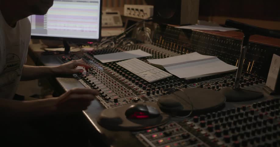 A man adjusts knobs on a mixer