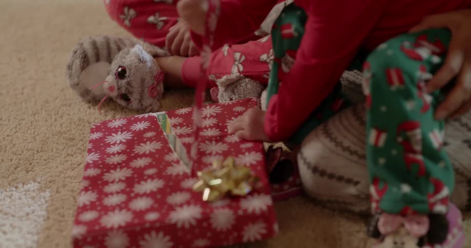 A young child opens a christmas present