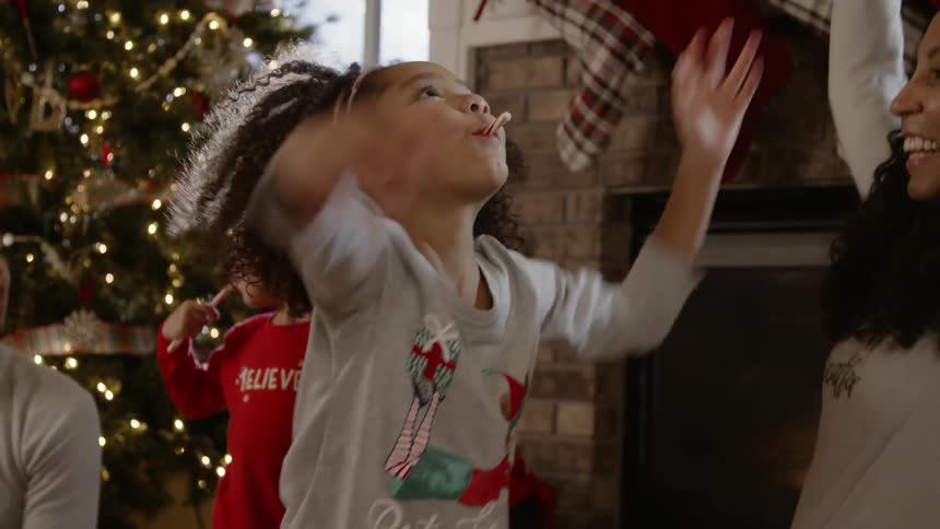 Young girl tosses wrapping paper into the air
