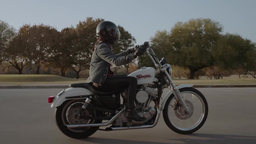 Motorcyclist rides down a highway
