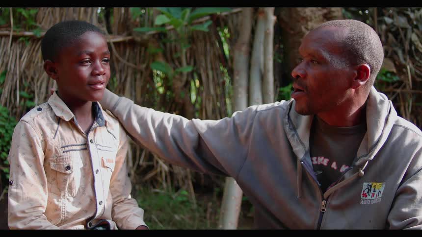 A man and boy talk outside