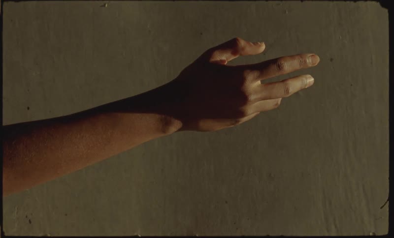 An outstretched hand rotates and closes