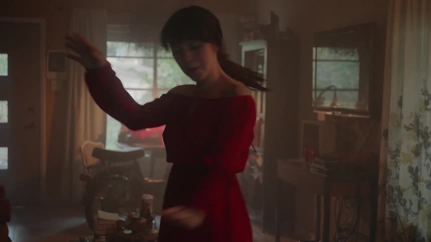 A woman dances in a living room