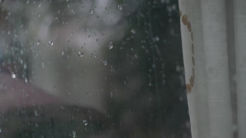 Rain droplets cover a window