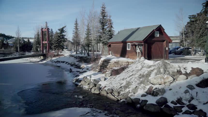 Icy steam flows behind a cabin in the country