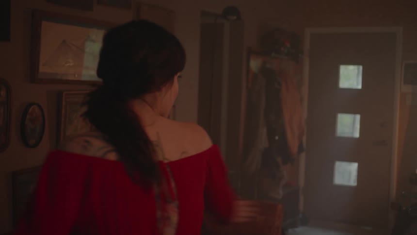 Woman dances in a dim room