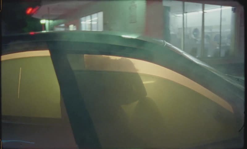 Smoke billows out of a car and person opens car door