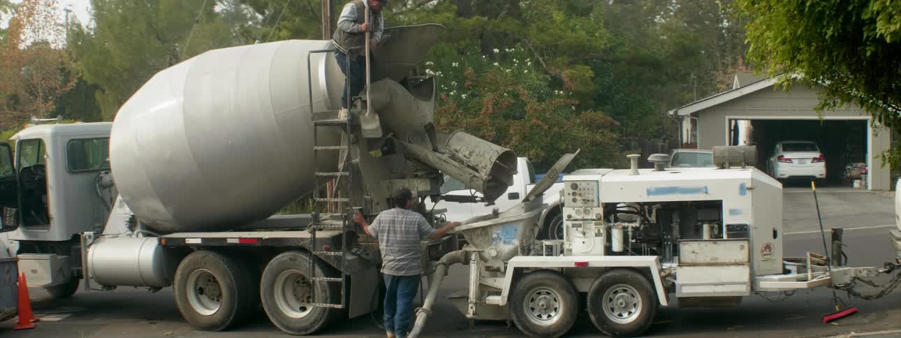 Concrete is poured from a concrete truck
