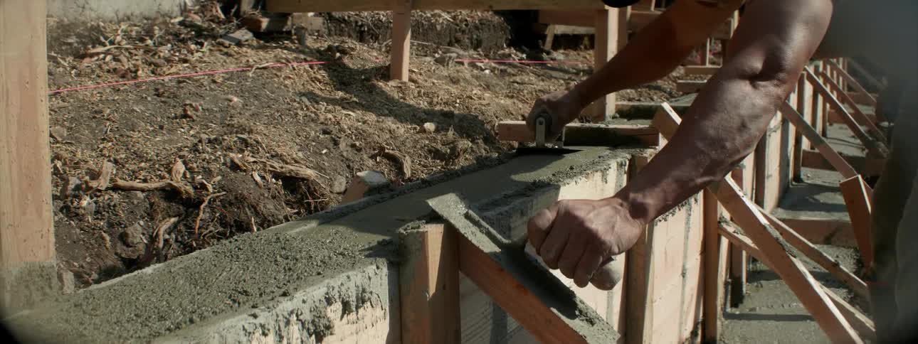 Someone is smoothing out freshly poured concrete