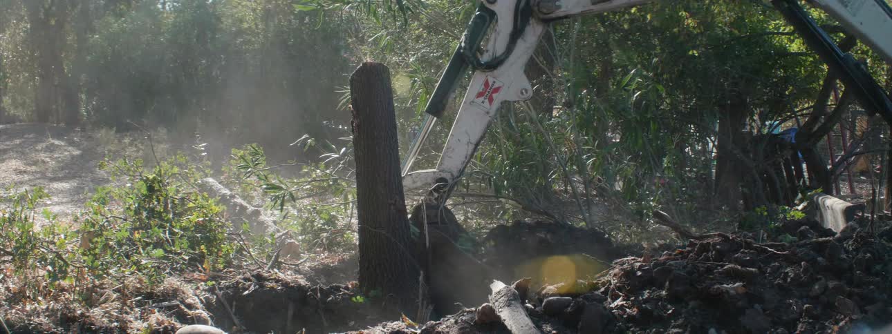 A digger excavates dirt at a job site