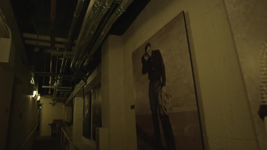 View of photograph portraits line a dim hallway