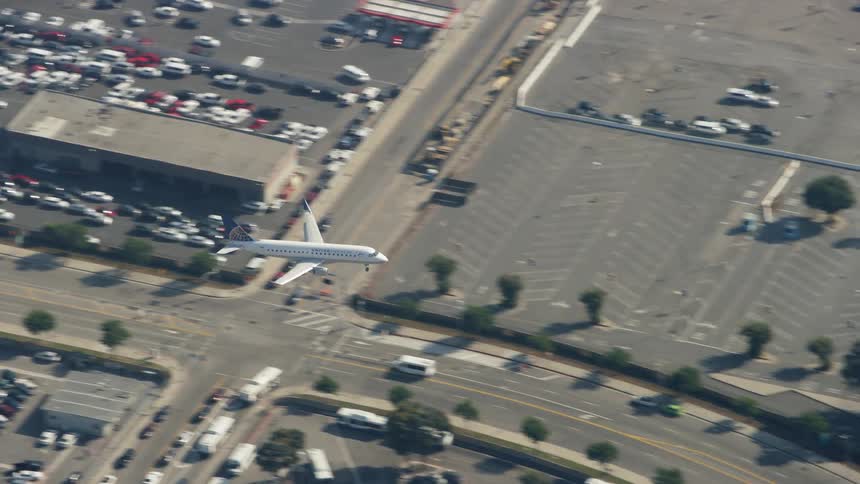An airplane is coming in a for a landing at an airport during the day