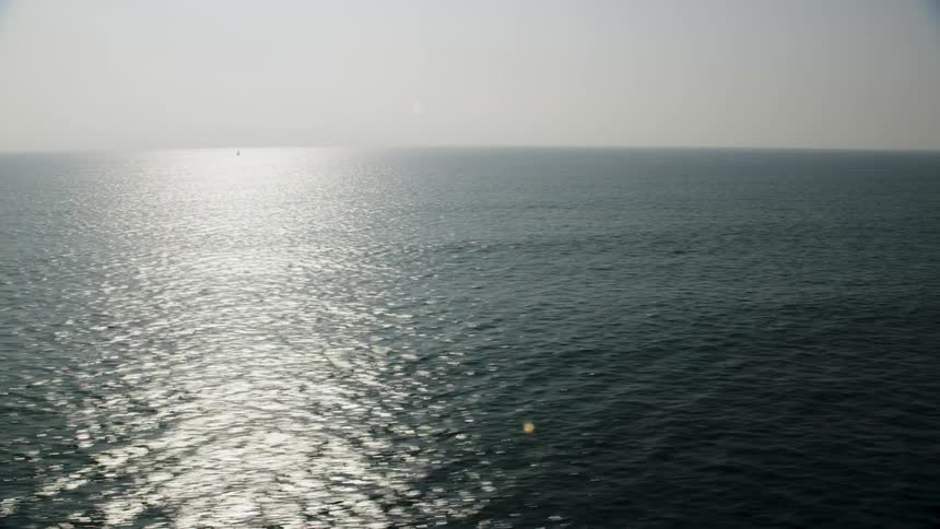 The sun is reflecting off the large body of water