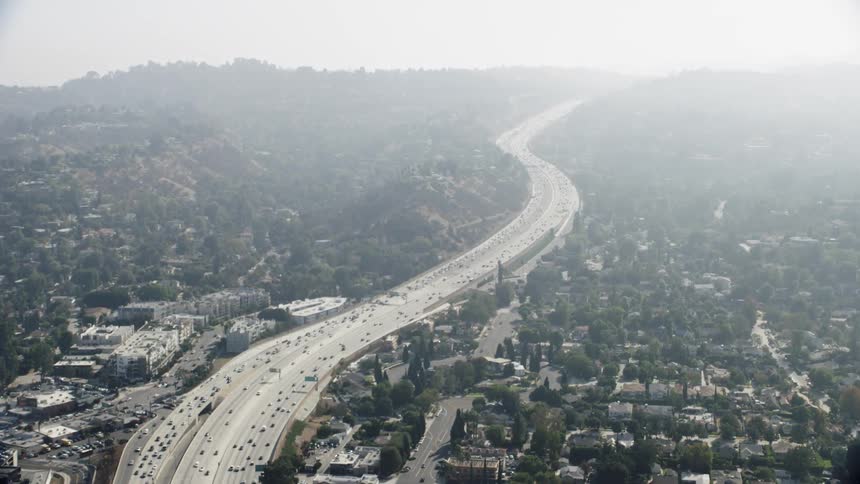 Cars drive on a city highway