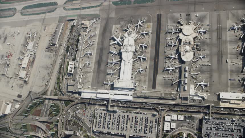 The planes are all parked around the hangars