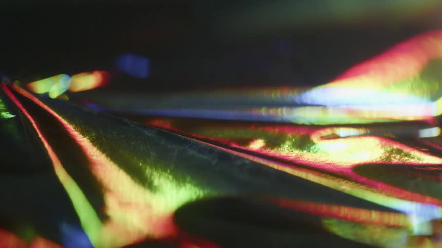 Light shines over a bumpy black surface