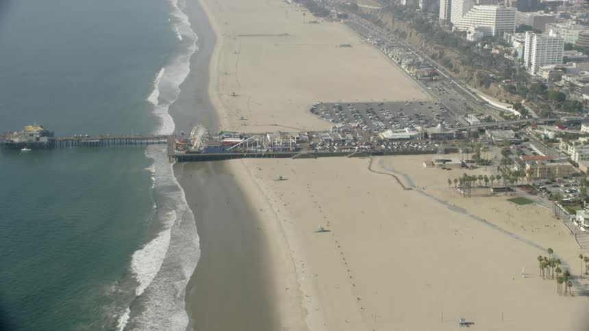 Amusement park rides sit on an ocean pier