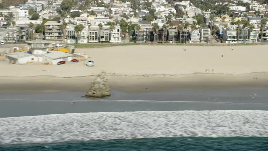 Ocean waves wash ashore a sandy beach
