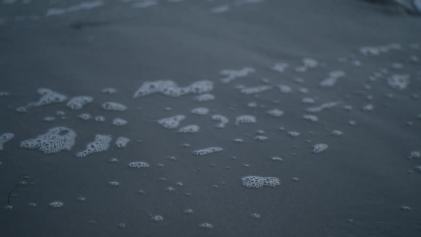 Ocean water flows over sand