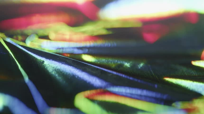 Rainbow lights shine on a still surface