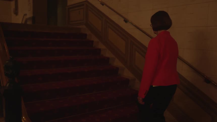 A woman walks up the stairs in a theater