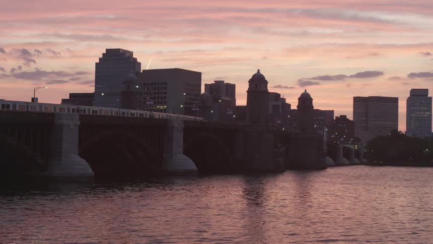 City skyline view at sunset as a commuter train passes by