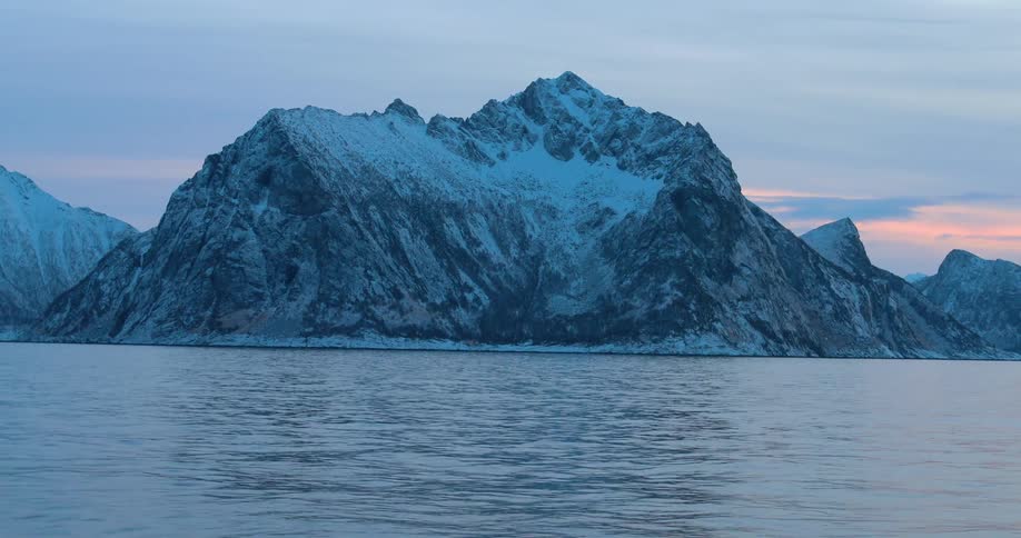 Mountain rising from the cold sea on a cloudy day