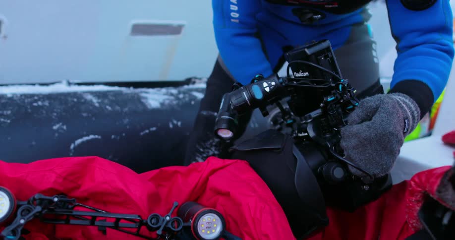 Person holding a large underwater camera
