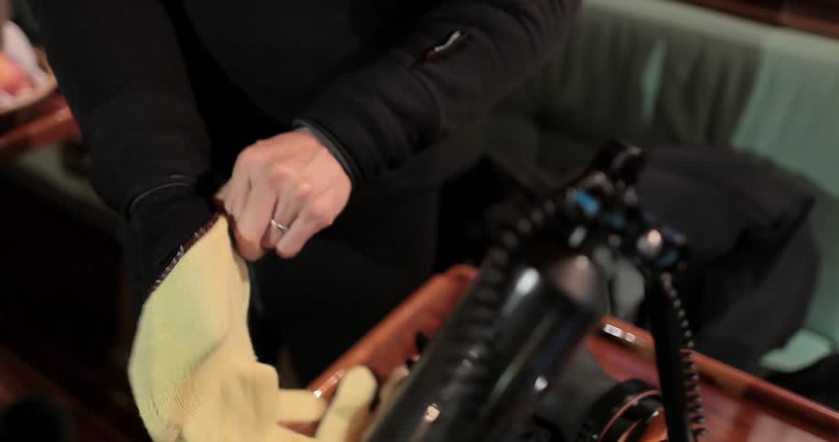 A man puts on thick gloves