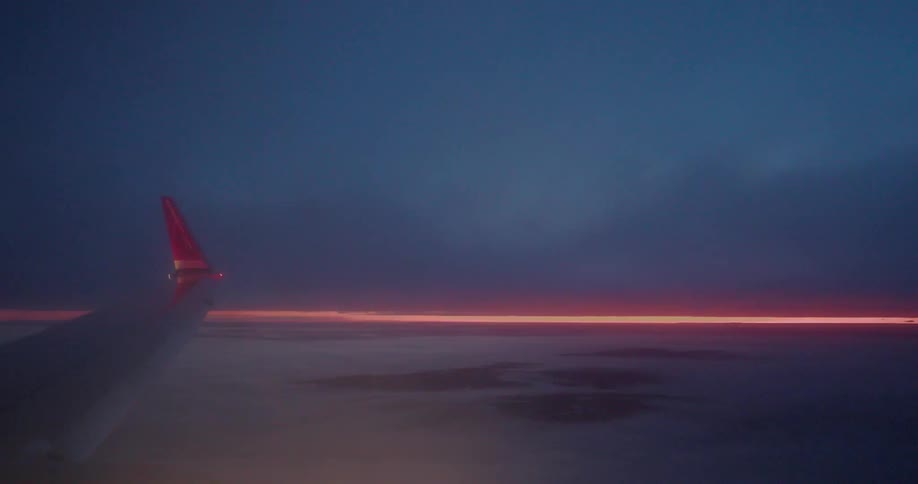 A plane flies above the clouds
