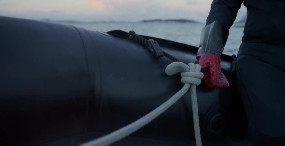 A person hangs onto a rope on a powerboat